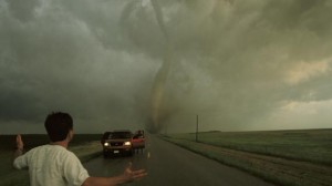 A man watching a nearby tornado